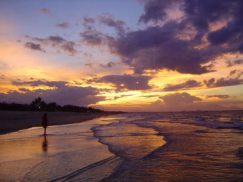 A walk along the water at golden hour on Hà My Beach
